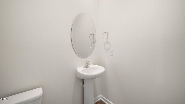 273 Hanging Elm Ln, Fuquay Varina, NC 27526 - half bathroom with toilet and baseboards