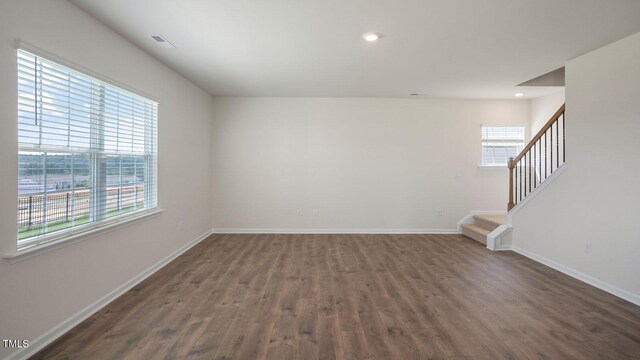 273 Hanging Elm Ln, Fuquay Varina, NC 27526 - empty room with healthy amount of natural light, dark wood-style floors, stairs, and recessed lighting