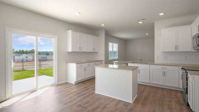 kitchen featuring white cabinets, plenty of natural light, and stainless steel appliances