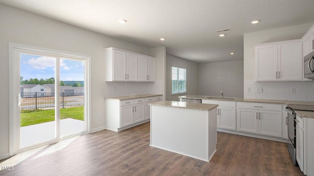 273 Hanging Elm Ln, Fuquay Varina, NC 27526 - kitchen featuring appliances with stainless steel finishes, tasteful backsplash, white cabinetry, a peninsula, and recessed lighting