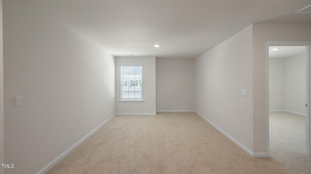 unfurnished room with light carpet