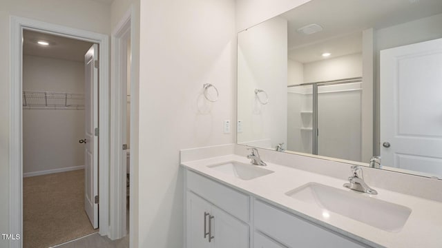 bathroom featuring vanity and an enclosed shower