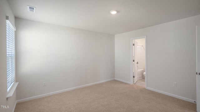 spare room with light carpet