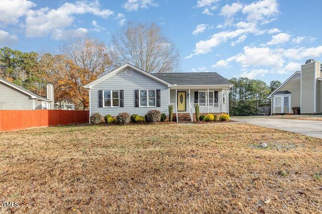 single story home with a front lawn and covered porch