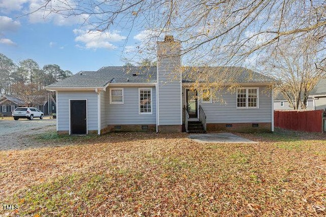 back of house with a lawn