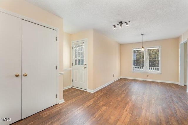 interior space with wood-type flooring and a textured ceiling