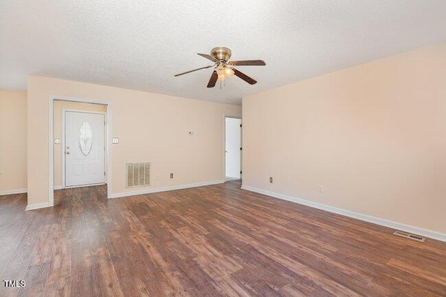 interior space with ceiling fan, dark wood-type flooring, and a textured ceiling