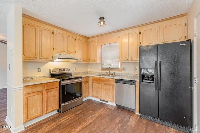 kitchen with sink, light brown cabinets, stainless steel appliances, dark hardwood / wood-style flooring, and a textured ceiling