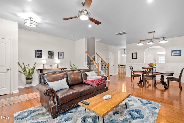 living room featuring ceiling fan and light wood-type flooring