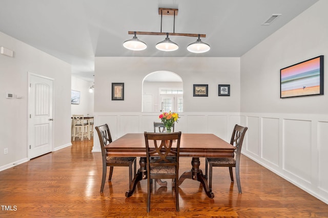 dining space with wood-type flooring