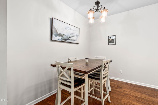 dining room featuring dark hardwood / wood-style floors and a notable chandelier