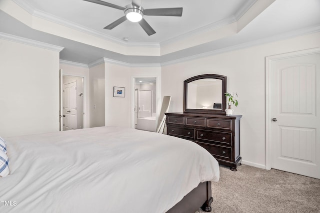 bedroom with ensuite bath, ceiling fan, crown molding, light colored carpet, and a tray ceiling