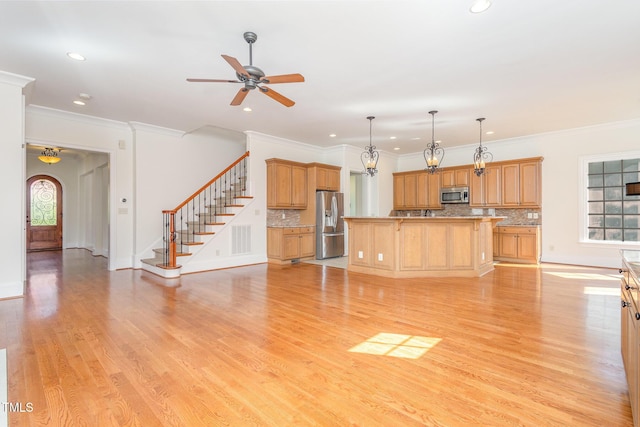 unfurnished living room featuring ceiling fan, ornamental molding, and light hardwood / wood-style flooring