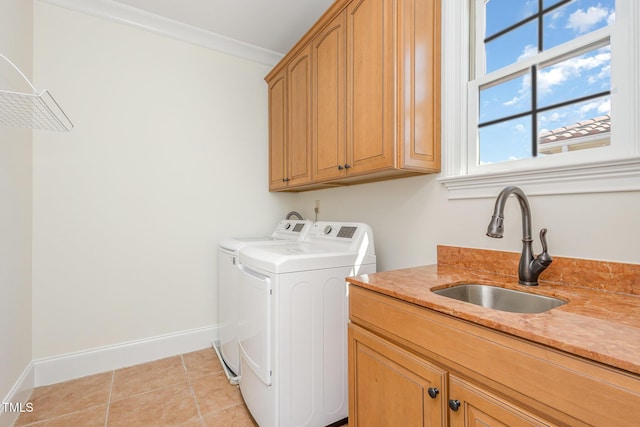 clothes washing area with sink, cabinets, independent washer and dryer, crown molding, and light tile patterned floors