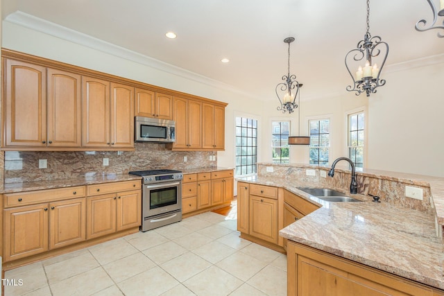 kitchen with light stone countertops, stainless steel appliances, sink, pendant lighting, and a chandelier