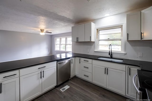 kitchen featuring appliances with stainless steel finishes, white cabinetry, sink, and a wealth of natural light