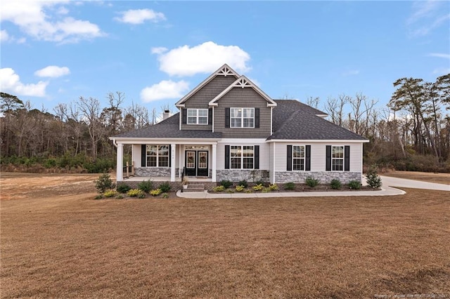 craftsman inspired home featuring a front yard and a porch