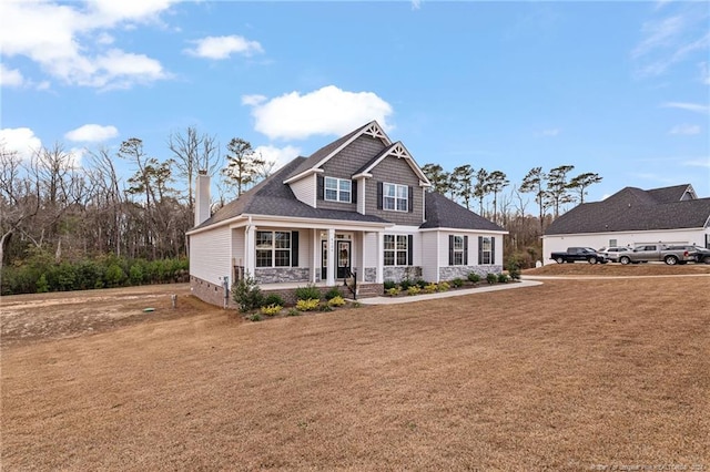 craftsman house featuring a porch and a front yard