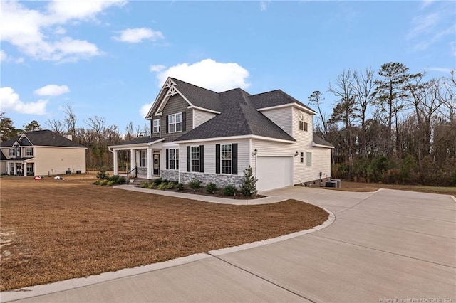 view of front of home featuring a porch, central AC unit, and a garage