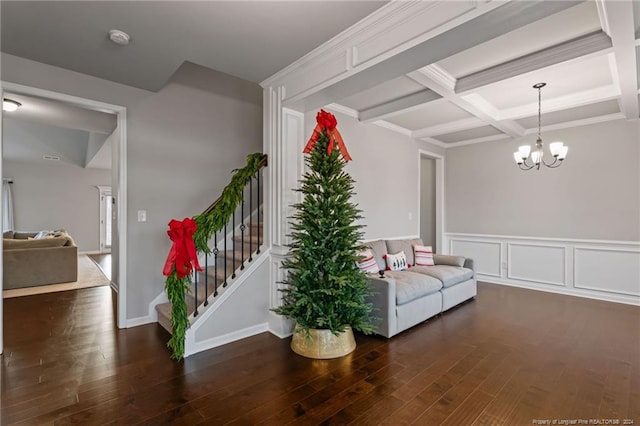 sitting room featuring an inviting chandelier, dark wood-type flooring, and coffered ceiling