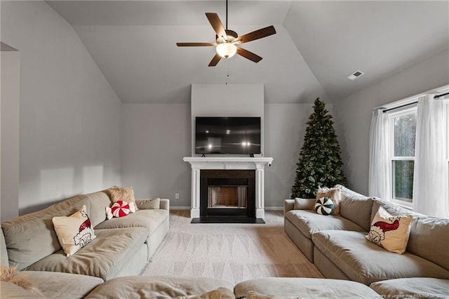 living room featuring ceiling fan, light colored carpet, and vaulted ceiling