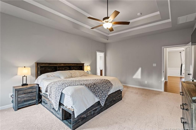 bedroom featuring a raised ceiling, ceiling fan, carpet flooring, and crown molding