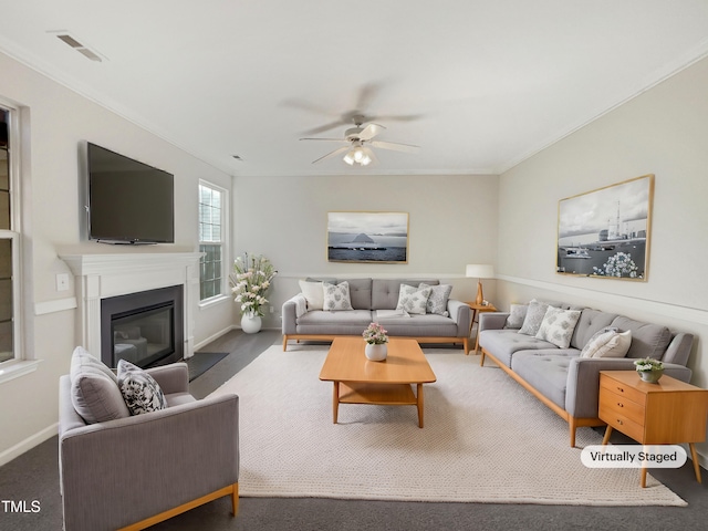 carpeted living room with ceiling fan and ornamental molding