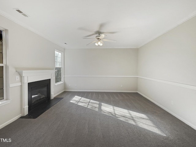 unfurnished living room featuring crown molding, ceiling fan, and dark carpet