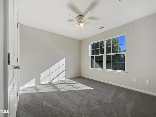 carpeted spare room featuring ceiling fan