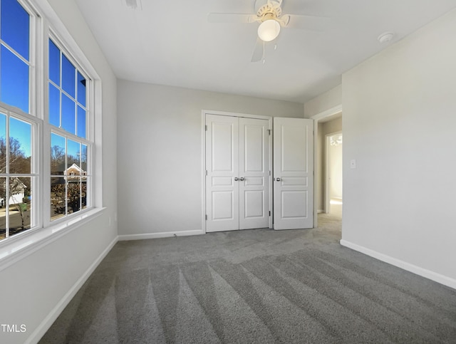 unfurnished bedroom featuring carpet flooring, ceiling fan, and a closet