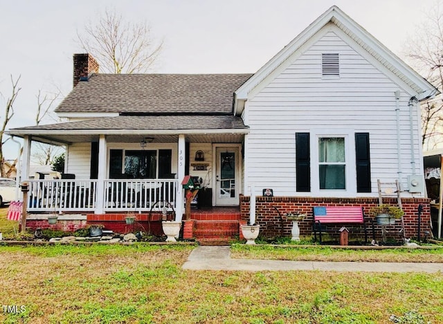 bungalow with a porch and a front yard