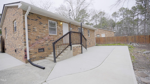 view of side of home with a patio