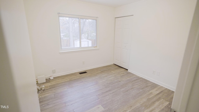 spare room featuring light hardwood / wood-style floors