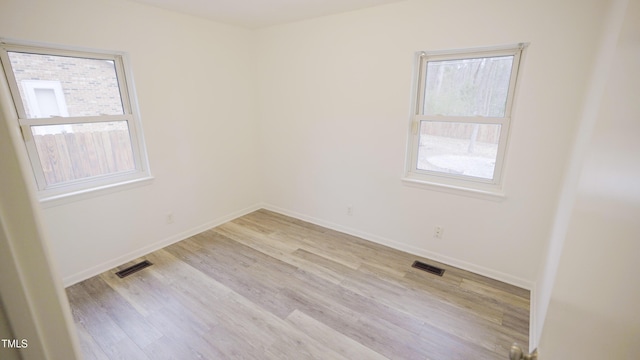 unfurnished room with light hardwood / wood-style flooring