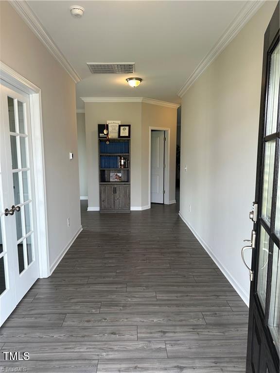 interior space featuring ornamental molding, dark hardwood / wood-style flooring, and french doors