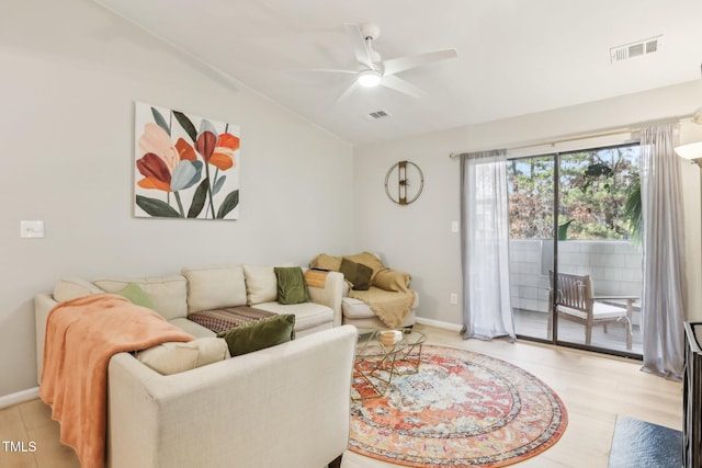 living room featuring ceiling fan, light hardwood / wood-style flooring, and vaulted ceiling