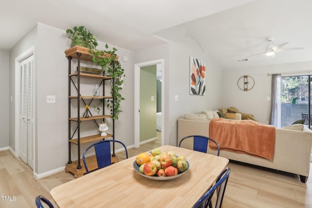 dining space with light hardwood / wood-style floors and ceiling fan