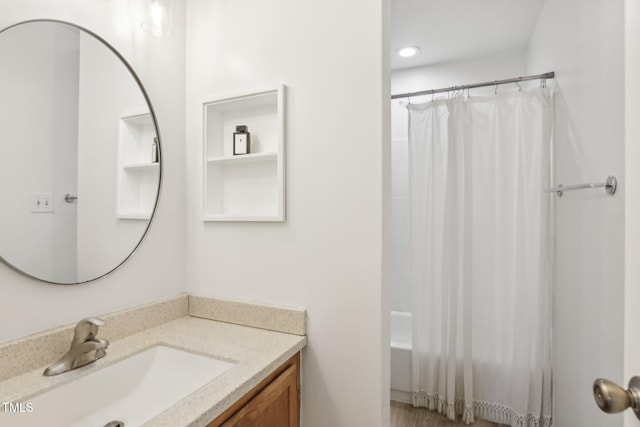 bathroom featuring shower / bath combination with curtain and vanity