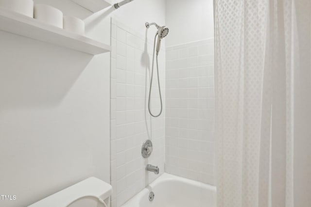 bathroom with shower / tub combo and toilet