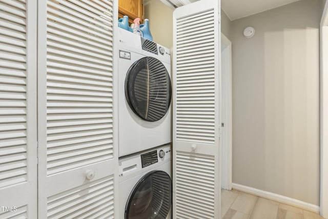 laundry area with stacked washer / drying machine