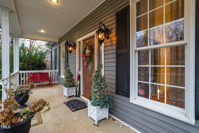 view of exterior entry with a porch