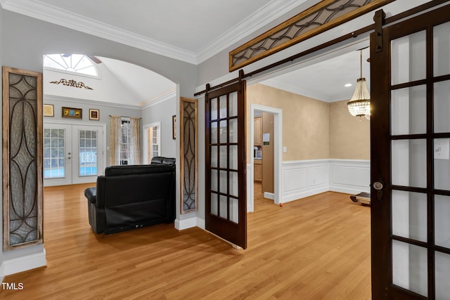 interior space featuring french doors, hardwood / wood-style flooring, plenty of natural light, and crown molding