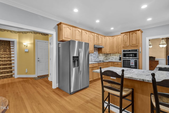 kitchen featuring backsplash, ornamental molding, light hardwood / wood-style floors, a kitchen bar, and stainless steel appliances