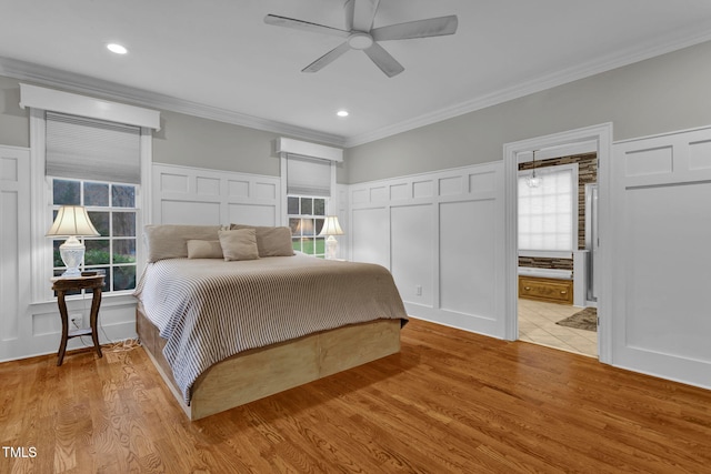 bedroom with ceiling fan, light hardwood / wood-style floors, ornamental molding, and multiple windows