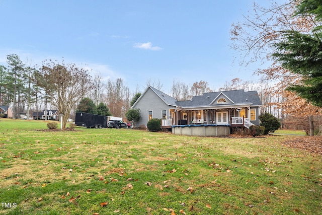 rear view of property featuring a yard