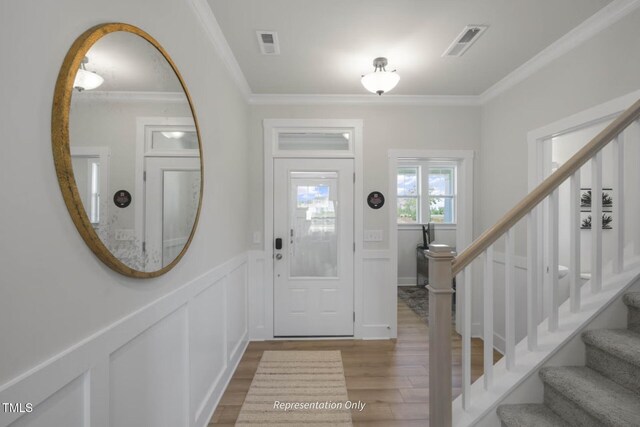 foyer featuring crown molding and light wood-type flooring