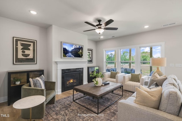 living room featuring hardwood / wood-style flooring and ceiling fan