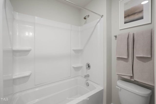 bathroom with shower / washtub combination and toilet