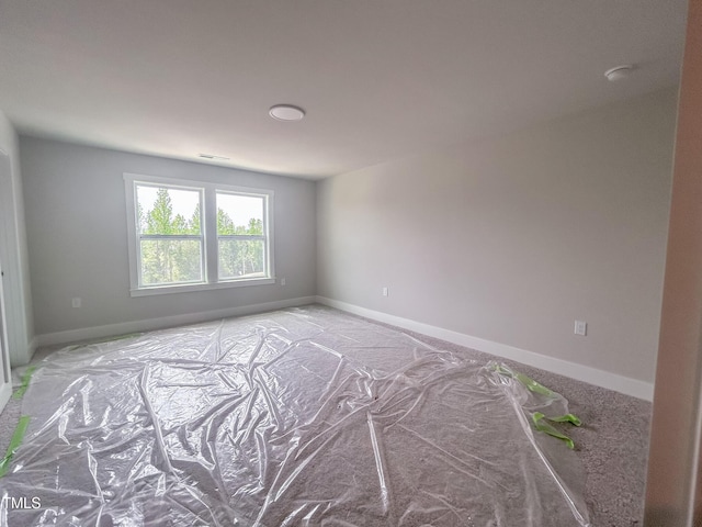 unfurnished room featuring baseboards