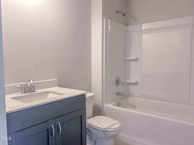 bathroom with toilet, vanity, and washtub / shower combination